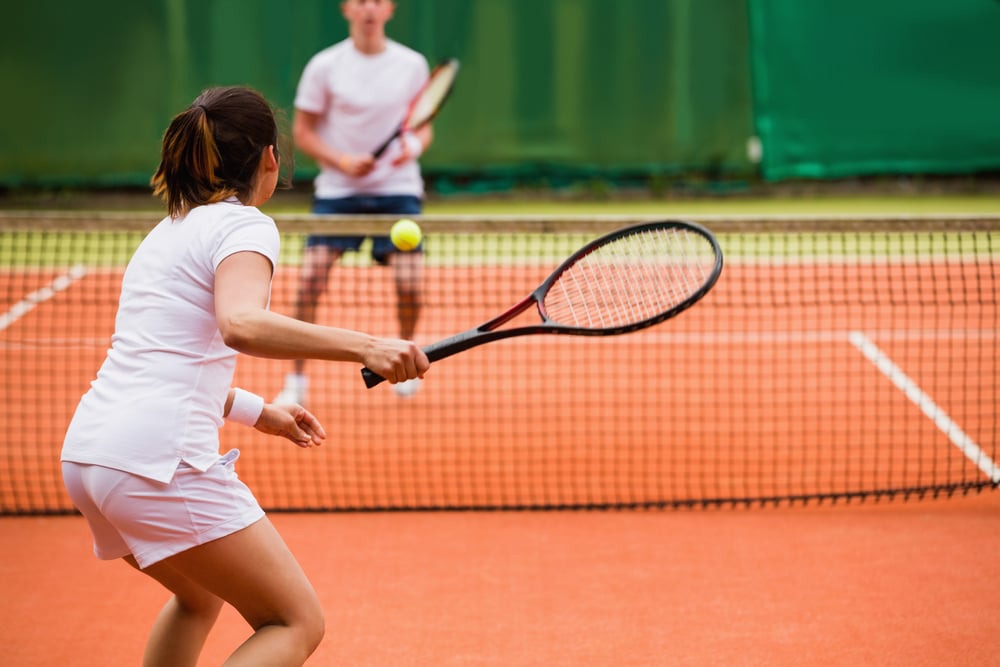 couple playing tennis 