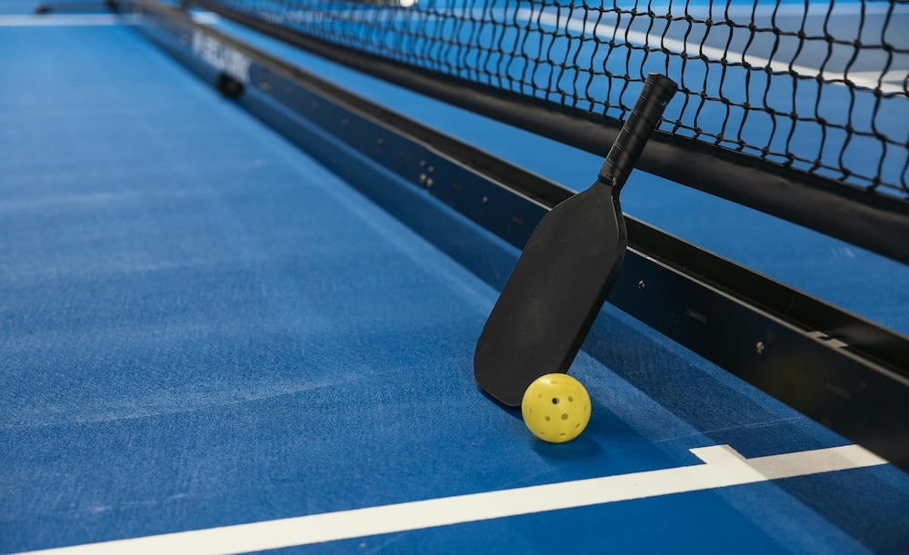 pickelball court with paddle and ball